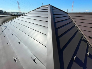 横暖ルーフαプレミアムSでカバー工事を行い、重厚感のある輝きを放つ施工後の屋根